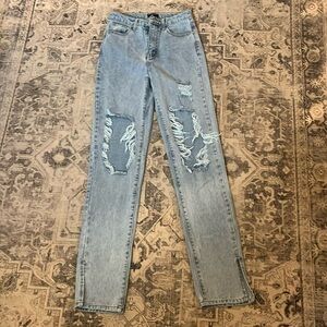 Pretty little thing tall light blue ripped knee split hem denim jeans. Size 2.